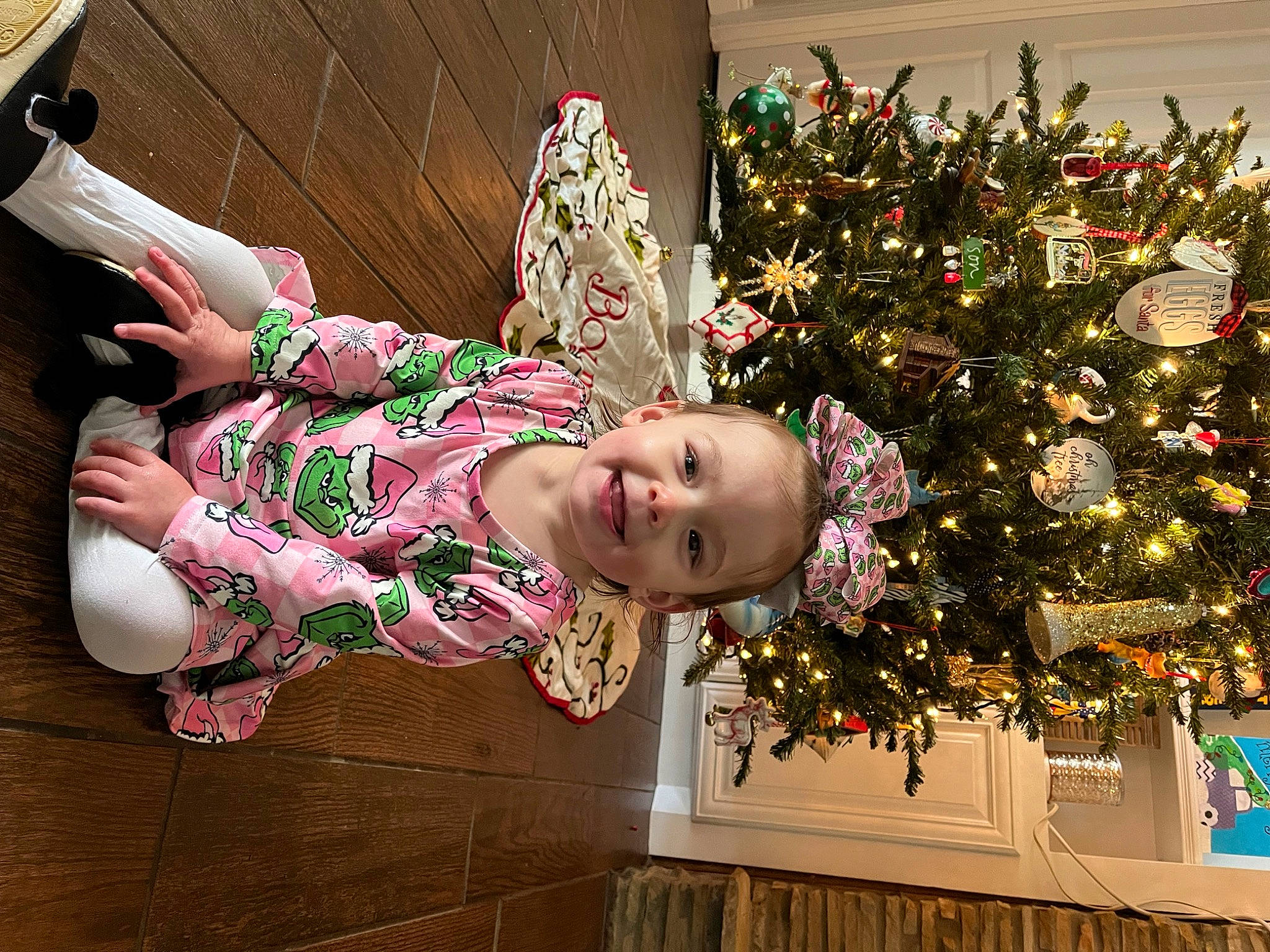 Zara is registered to the contest to win money with this photo: baby_toddler_clothing, carmine, child, christmas_decoration, christmas_ornament, christmas_tree, event, fun, happy, holiday, holiday_ornament, joy, magenta, ornament, pattern, person, pink, plant, room, smile