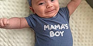 Mason is registered to the contest to win money with this photo: baby, infant, smiling, blue_clothing, striped_hat, striped_pants, lying_down, blanket, toys, cute, happy, child, portrait, indoor, mama's_boy, arms_up, face, headwear, toddler, playpen