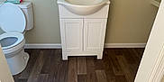 Maggie is registered to the contest to win money with this photo: bathroom, bathroom_cabinet, bathroom_sink, cabinetry, comfort, floor, flooring, grey, household_hardware, interior_design, plumbing, plumbing_fixture, property, purple, rectangle, sink, tap, toilet, toilet_seat, wood