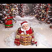 Willowrose is registered to the contest to win money with this photo: baby, child, santa_hat, red_clothing, basket, christmas_tree, holiday_decorations, stocking, snow, festive_lights, ornaments, plush_toys, winter_theme, cute, portrait, indoor, celebration, smiling, holiday, christmas