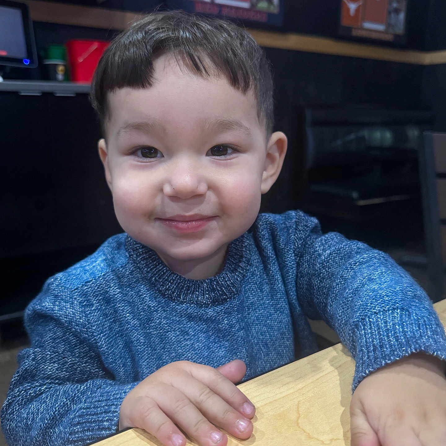 Jeremiah is registered to the contest to win money with this photo: bodypart, boy, child, clothing, electronics, face, finger, hand, happy, hardwood, head, knitwear, male, person, photography, plywood, portrait, smile, sweater, wood