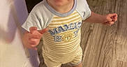 Hayden joined the competition — help win amazing prizes! toddler, child, smiling, barefoot, indoor, wooden_floor, onesie, clothing, standing, happy, face, person, baby, cute, home, flooring, doorframe, playroom, bright_eyes, striped_clothing