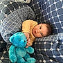 baby, blanket, blue, child, comfort, cozy, cuddly, cute, gray, indoors, pattern, person, plush_toy, portrait, resting, smiling, soft, teddy_bear, warm, young