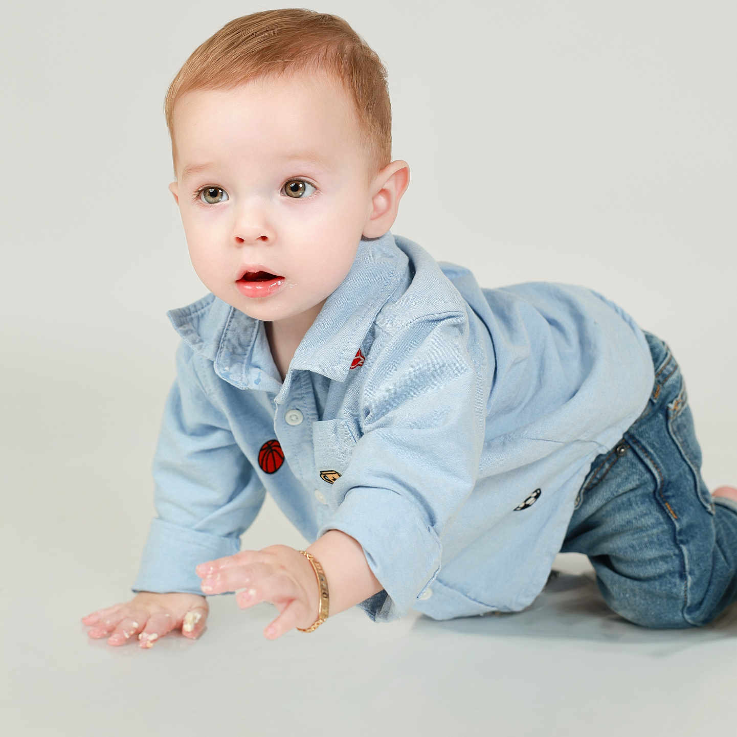 Diago León joined the competition — help win amazing prizes! adorable, baby, blue_clothing, child, crawling, denim, eyes, face, fashion, hands, indoor, jeans, kneeling, light_background, open_mouth, photography, portrait, shirt, short_hair, studio