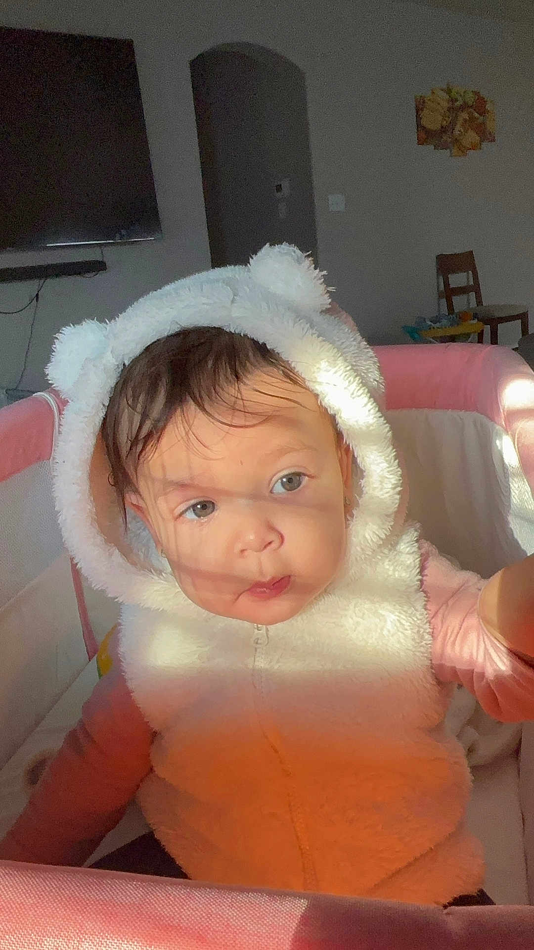 Yaimari joined the competition — help win amazing prizes! baby, child, clothing, curious, cute, eyes, face, fur, headwear, hoodie, indoor, light, person, pink, playpen, plush, portrait, shadow, white, young