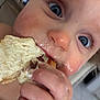 toddler, child, close_up, bread, food, messy, face, blue_eyes, hand, snack, eating, curious, indoor, skin, mouth, fingers, hair, nose, cheeks, young_child