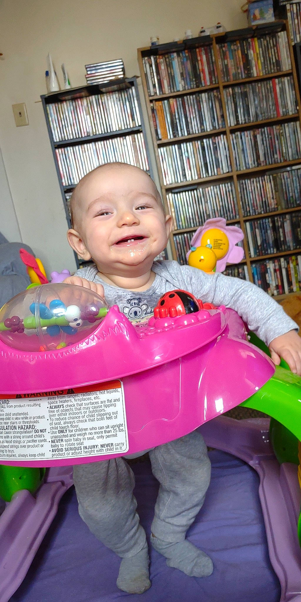 Aidyn is registered to the contest to win money with this photo: baby, baby_toddler_clothing, bookcase, cheek, child, event, facial_expression, fun, green, happy, joy, magenta, person, photograph, pink, product, purple, shelf, skin, smile
