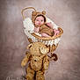 baby, infant, knitted_clothing, bear_ears, wicker_basket, plush_toy, teddy_bear, soft_fabric, portrait, studio_photography, child, cute, smiling, cozy, warm_lighting, neutral_background, fuzzy_texture, seated, small_hands, baby_feet