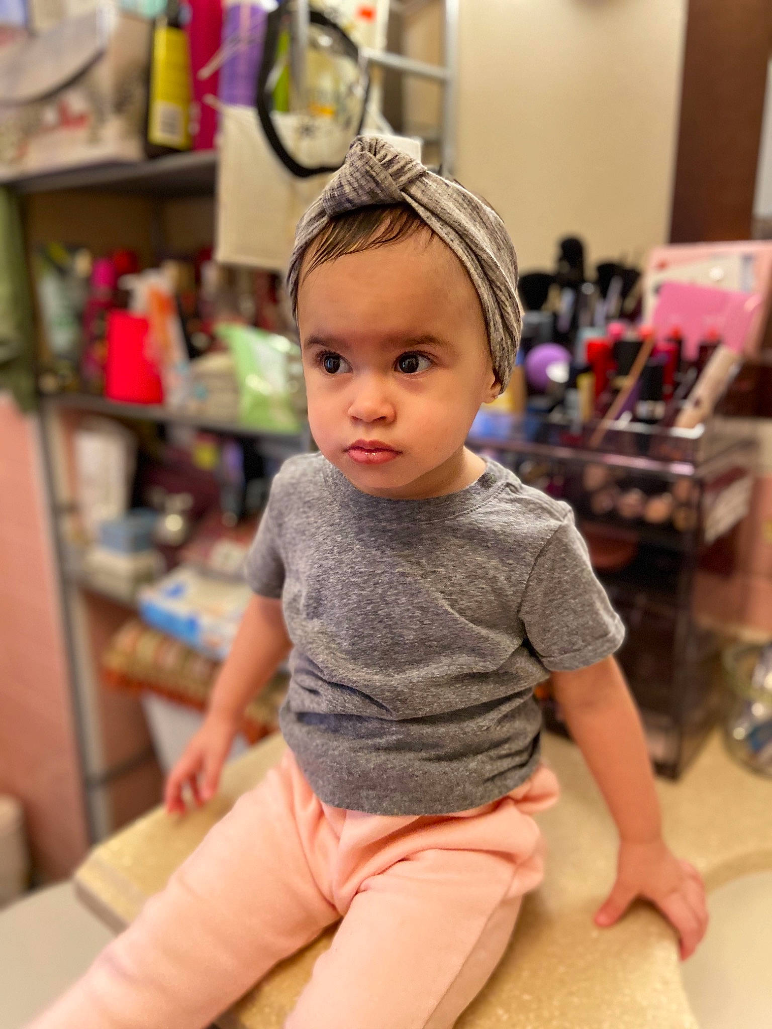 Melani is registered to the contest to win money with this photo: baby, cheek, child, child_model, ear, hair_accessory, hairstyle, head, headband, neck, person, pink, room, sleeve, t_shirt, toddler
