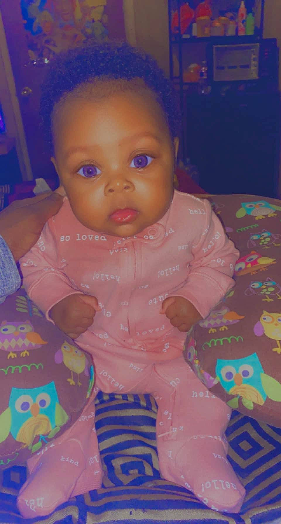 Kaylani is registered to the contest to win money with this photo: baby, baby_toddler_clothing, cheek, child, doll, dress, eyelash, facial_expression, fun, head, human_body, iris, lip, mouth, nose, person, pink, skin, textile, toddler