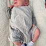 baby, infant, towel, striped_clothing, socks, heart_symbol, mama_text, hand, soft_texture, newborn, cute, lying_down, child, apparel, footwear, person, skin, small, love, comfort