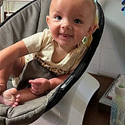Malachi is registered to the contest to win money with this photo: baby, baby_seat, bare_feet, bottle, bouncer, child, clothing, face, furniture, happy, home, indoor, infant, nursery, photography, portrait, sitting, smiling, toys, window_blinds