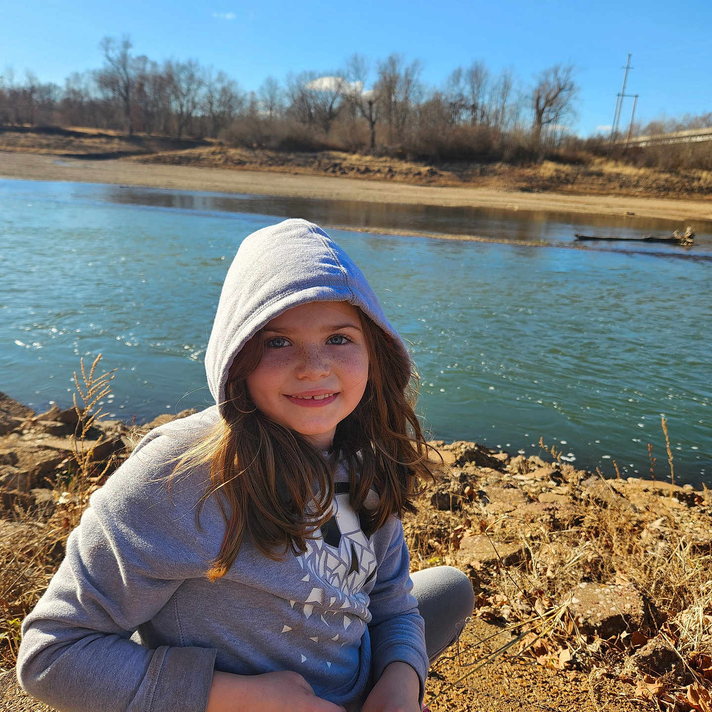 Avery is registered to the contest to win money with this photo: cap, child, clothing, face, female, girl, happy, hat, head, knitwear, lake, nature, outdoors, person, photography, portrait, smile, soil, sweater, water
