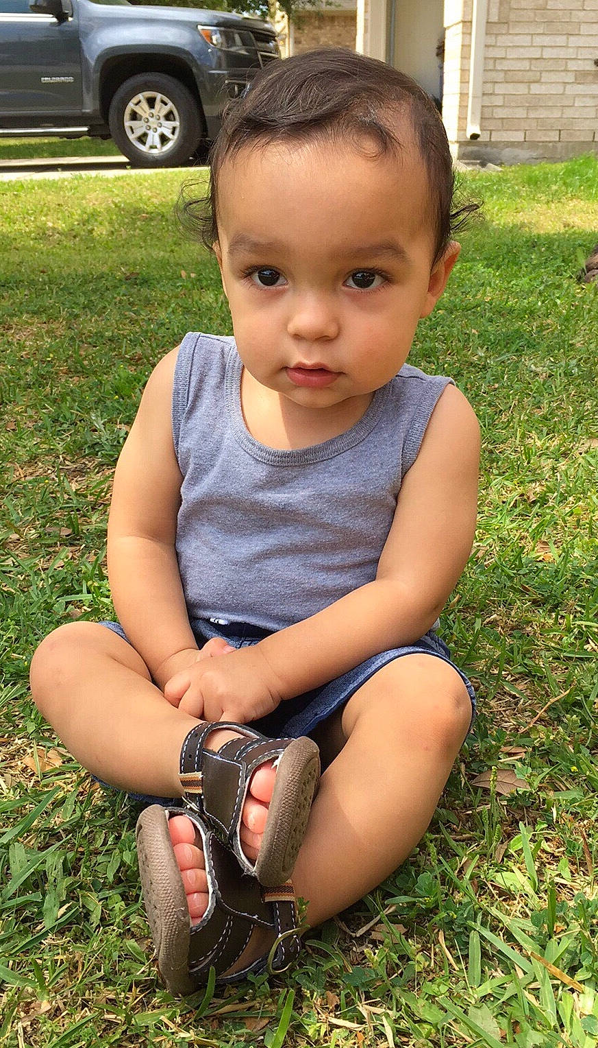 Davian is registered to the contest to win money with this photo: child, grass, lawn, person, plant, play, sitting, toddler