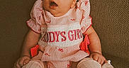 Wren is registered to the contest to win money with this photo: baby, bow, child, clothing, couch, cute, expression, fabric, hands, headband, home, indoors, infant, legs, person, pink_outfit, portrait, shoes, sitting, young