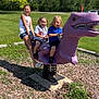 casual_clothing, child, children, cloudy_sky, dinosaur, footwear, fun, glasses, grass, happy, outdoor, park, play, playground, shorts, smile, spring_rocker, summer, sunny, tree