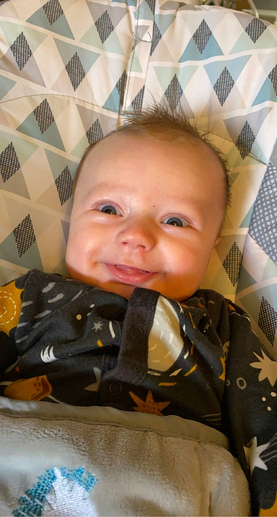 Jaxtyn is registered to the contest to win money with this photo: baby, baby_products, baby_safety, baby_toddler_clothing, cheek, child, comfort, finger, fun, gesture, happy, laugh, linens, pattern, person, personal_protective_equipment, sitting, skin, smile, thumb