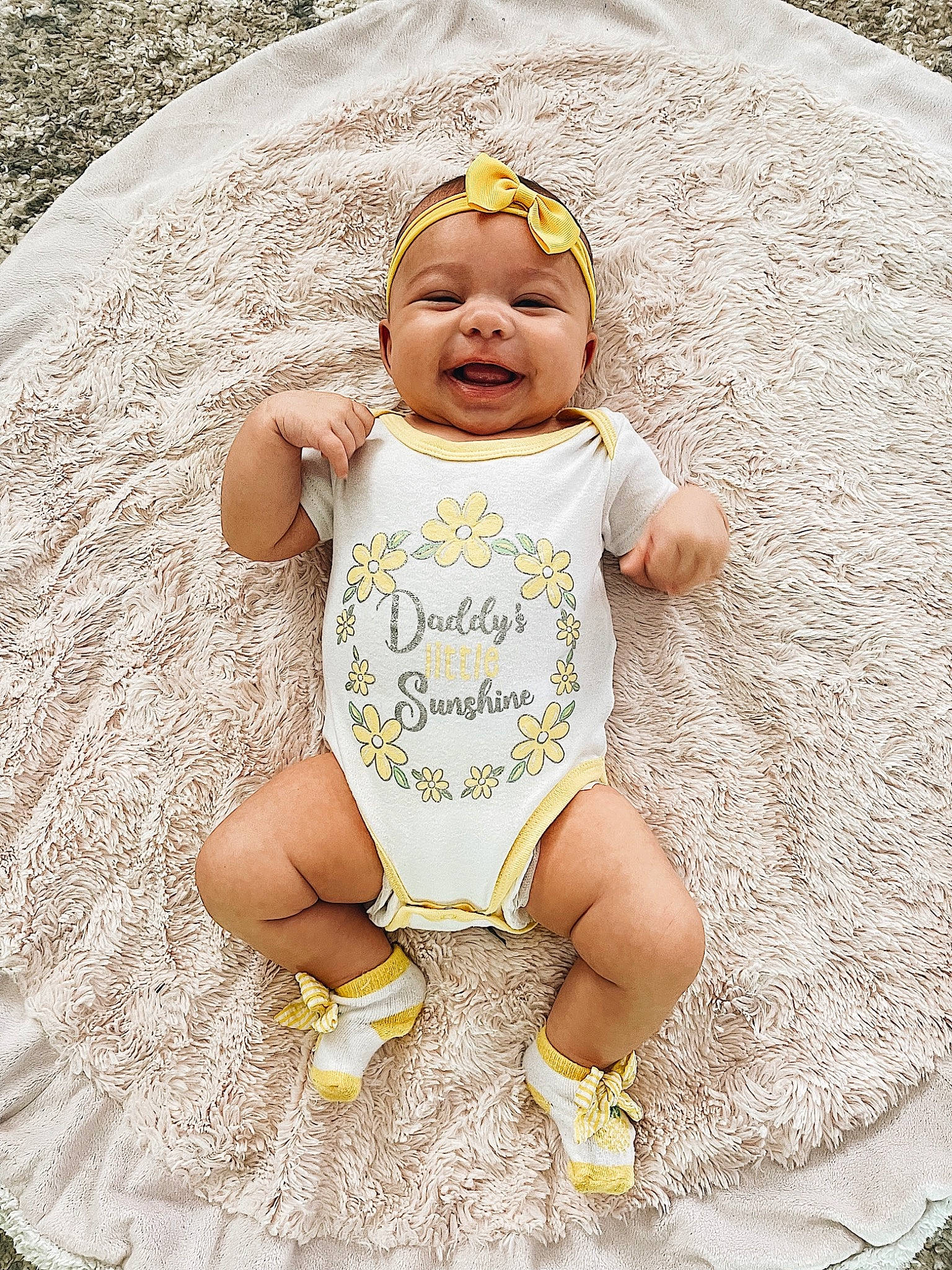 Nevaeh is registered to the contest to win money with this photo: baby, baby_toddler_clothing, child, face, fun, grass, happy, hat, headwear, leisure, pattern, people_in_nature, person, personal_protective_equipment, recreation, shorts, sitting, skin, sleeve, smile