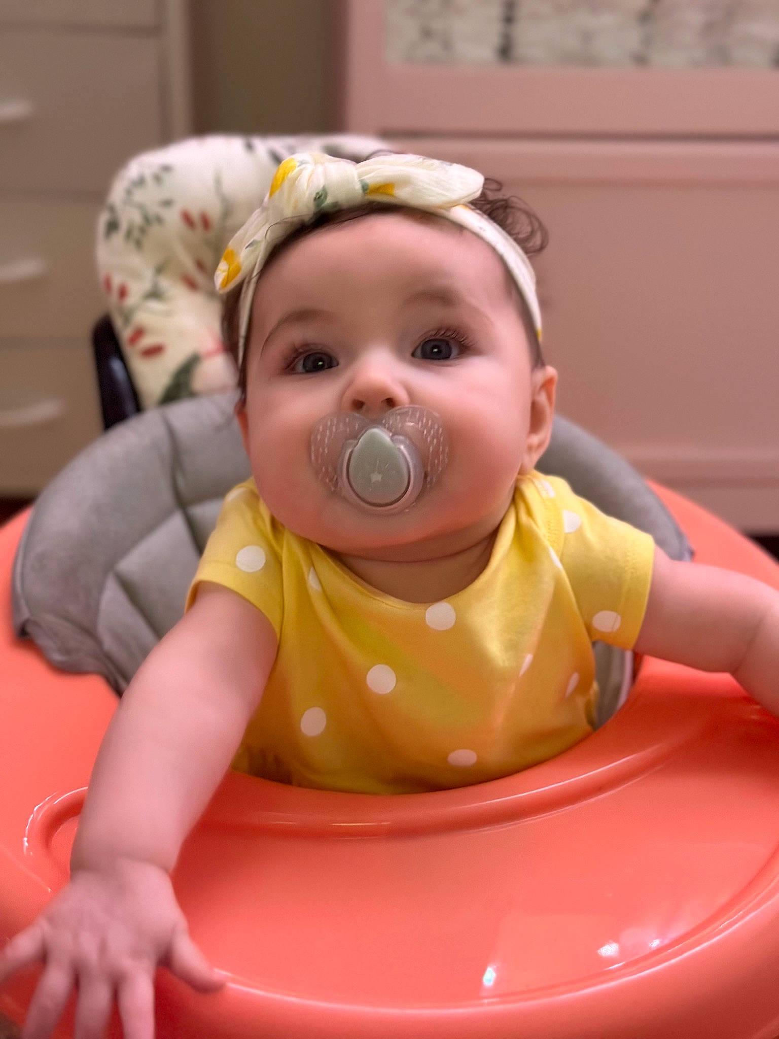 Mikeyla Rose joined the competition — help win amazing prizes! baby, baby_products, baby_toddler_clothing, baby_toys, bib, cheek, child, circle, comfort, crawling, flooring, fun, happy, headwear, leisure, person, pink, recreation, room, sitting