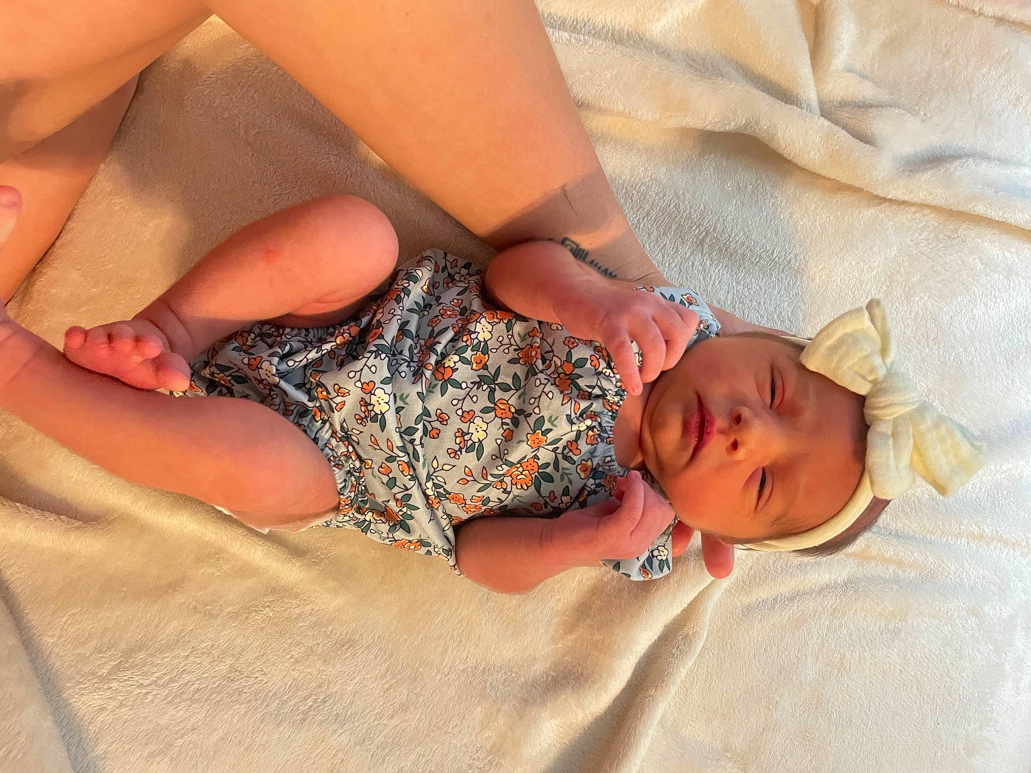 Elora is registered to the contest to win money with this photo: abdomen, arm, baby_sleeping, baby_toddler_clothing, comfort, dress, finger, hair, hand, head, headwear, human_body, joint, mouth, neck, person, skin, textile, thigh, toddler