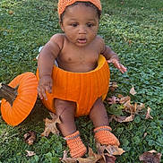 Javan is registered to the contest to win money with this photo: baby, pumpkin, grass, autumn, fall_leaves, knit_hat, knit_booties, outdoor, child, cute, nature, seasonal, orange, sitting, leaf_litter, baby_boy, costume, holiday, harvest, playful