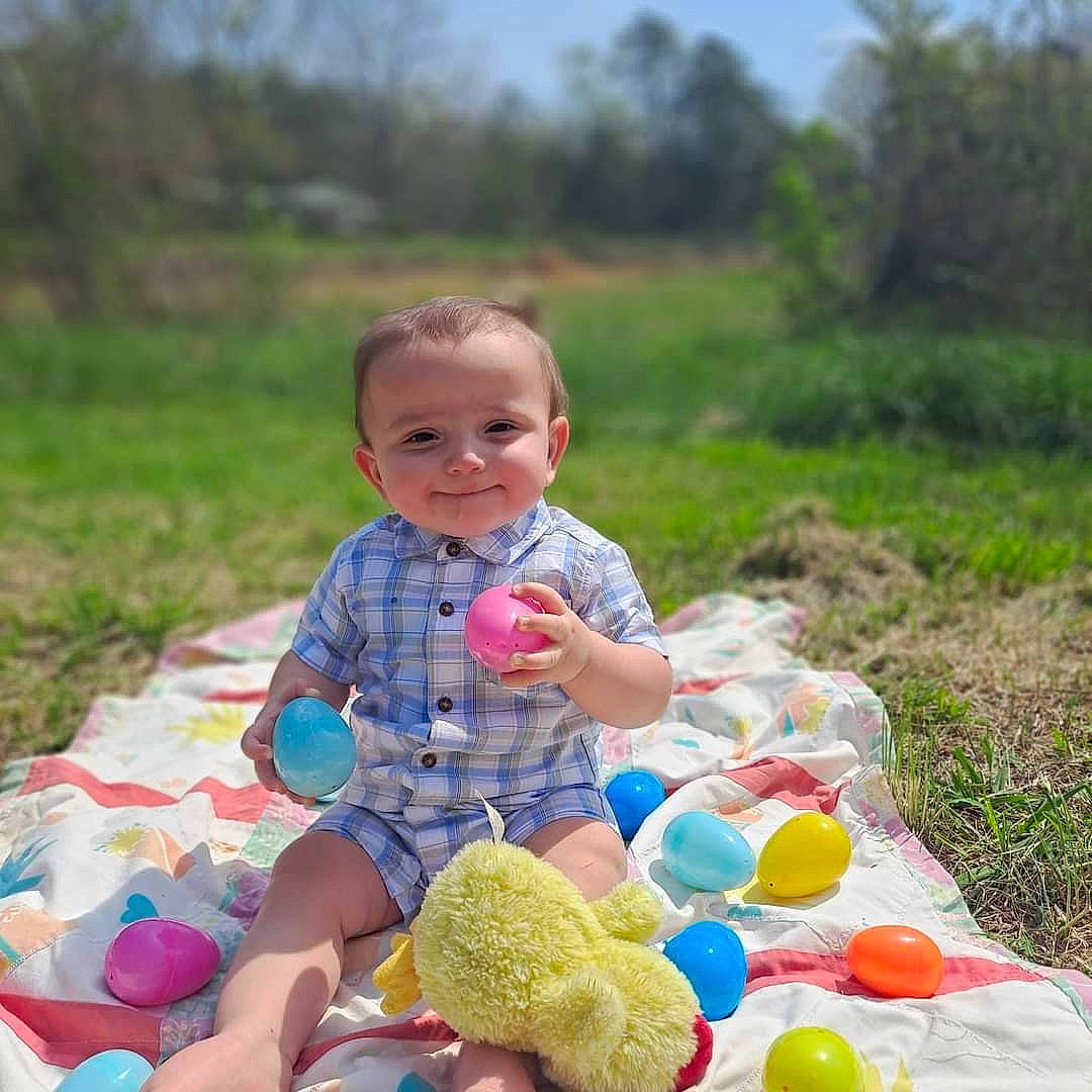 Jase is registered to the contest to win money with this photo: baby, baby_toddler_clothing, balloon, child, event, fun, grass, happy, joy, leisure, people_in_nature, person, plant, play, recreation, sitting, sky, smile, summer, toddler
