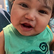 Asher joined the competition — help win amazing prizes! child, toddler, smiling, face, green_shirt, tank_top, indoors, cute, happy, baby, person, portrait, hair, skin, closeup, expression, young_child, chameleon_graphic, clothing, casual