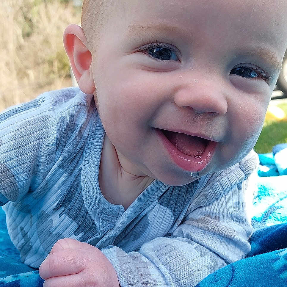 Jaxson joined the competition — help win amazing prizes! baby, babylaughing, bodypart, clothing, face, finger, hand, happy, head, laughing, mouth, pants, person, photography, plant, portrait, quilt, smile, teeth, tree