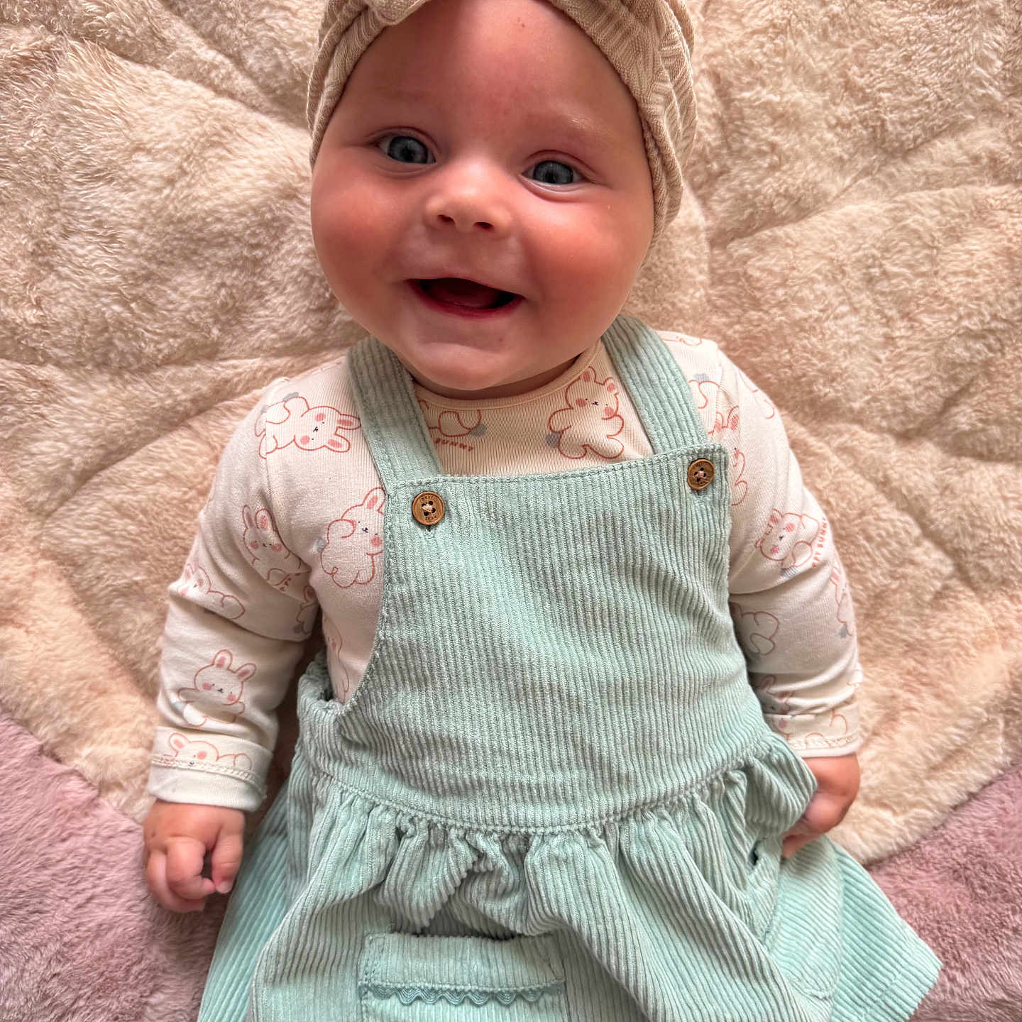 Alexis Page is registered to the contest to win money with this photo: baby, blanket, blue_eyes, button, child, clothing, corduroy_dress, cute, face, hand, happy, headband, indoor, infant, lying_down, mint_green, pocket, portrait, smiling, soft_texture