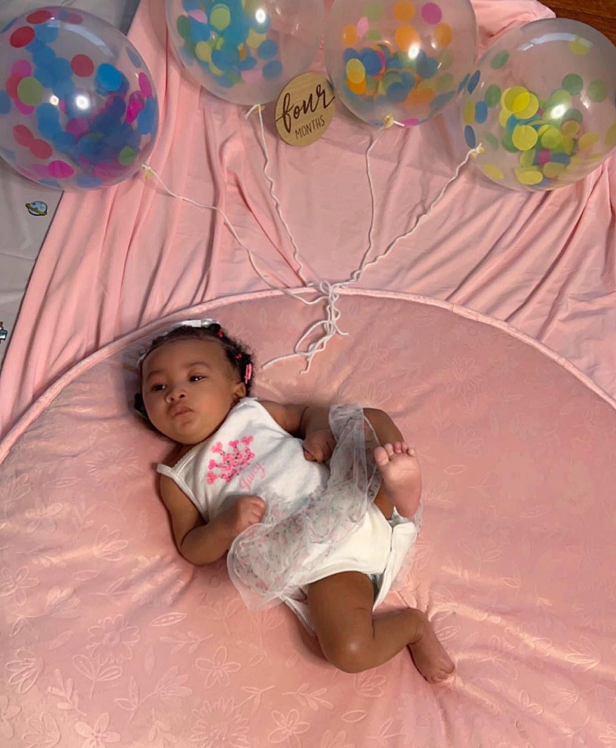 Wynter is registered to the contest to win money with this photo: baby, balloon, child, comfort, event, fun, happy, headwear, leisure, linens, magenta, party_supply, person, pink, play, recreation, room, sitting, sweetness, t_shirt