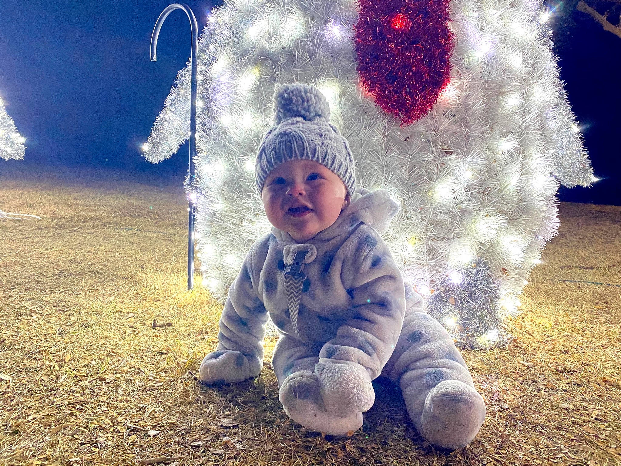 Gatlin joined the competition — help win amazing prizes! baby, baby_laughing, baby_toddler_clothing, beanie, christmas, christmas_decoration, christmas_eve, christmas_lights, headwear, holiday, knit_cap, ornament, party_supply, person, play, winter