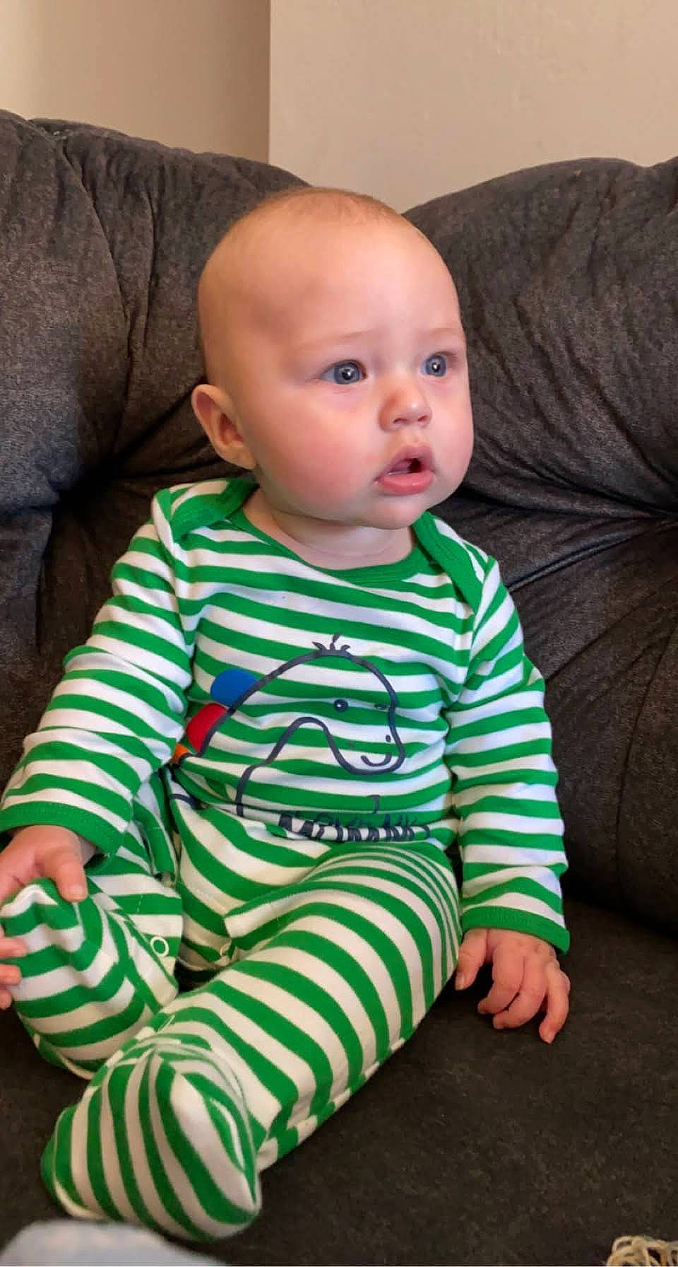 Gatlin is registered to the contest to win money with this photo: ankle, baby, baby_toddler_clothing, cheek, child, comfort, couch, ear, living_room, long_sleeved_t_shirt, nightwear, nose, person, sitting, skin, sleeve, slipcover, sock, toddler