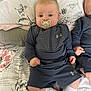 baby, pacifier, blue_eyes, under_armour, sportswear, bedspread, floral_pattern, infant, child, cute, lying_down, white_socks, hands, face, head, soft_lighting, indoor, twin, sleepwear, pillow