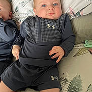 John joined the competition — help win amazing prizes! baby, infant, child, blue_eyes, under_armour, clothing, bed, sheet, leaf_pattern, twin, matching_outfits, cute, portrait, indoor, sitting, sock, hand, face, blanket, pajamas