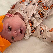 Everleigh is registered to the contest to win money with this photo: adorable, baby, baby_face, child, childhood, closeup, clothing, cozy, cute, expression, headband, holiday_theme, infant, lying_down, orange_bow, portrait, pumpkin_outfit, small_hand, soft_texture, white_fur