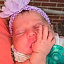 baby, sleeping, pacifier, headband, flower, hand, infant, closeup, skin, face, peaceful, child, cute, resting, newborn, window, brick_wall, clothing, purple, soft