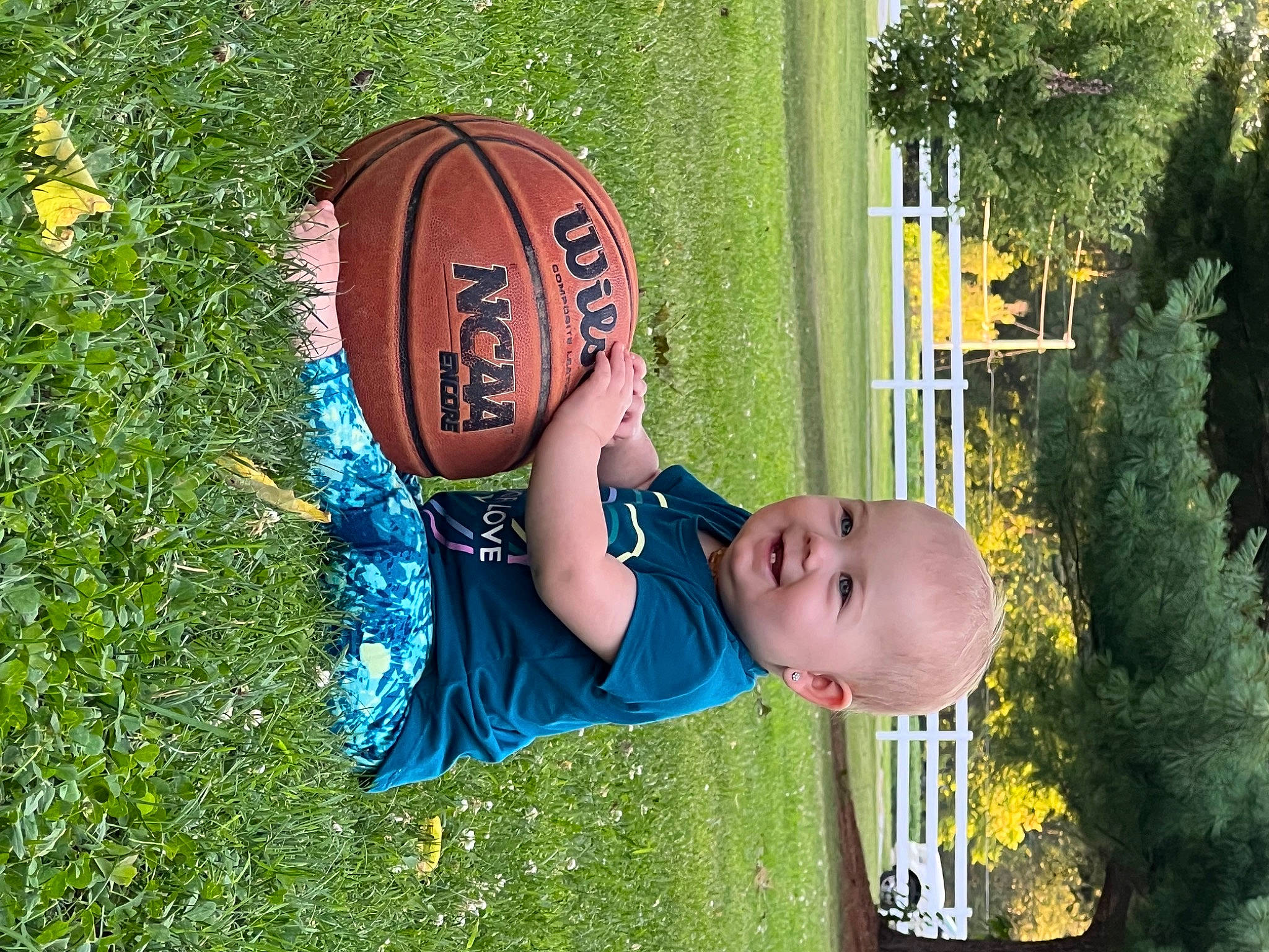 Oakleigh is registered to the contest to win money with this photo: baby, baby_toddler_clothing, ball, basketball, child, fun, grass, happy, joy, lawn, leisure, people_in_nature, person, personal_protective_equipment, plant, player, recreation, smile, sports_equipment, sports_gear
