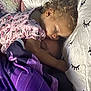Rosilee is registered to the contest to win money with this photo: bed, blanket, child, comfort, cozy, cuddle, curly_hair, cute, earring, face, home, indoor, nap, person, pillow, pink_clothing, rest, sleeping, soft_texture, toddler