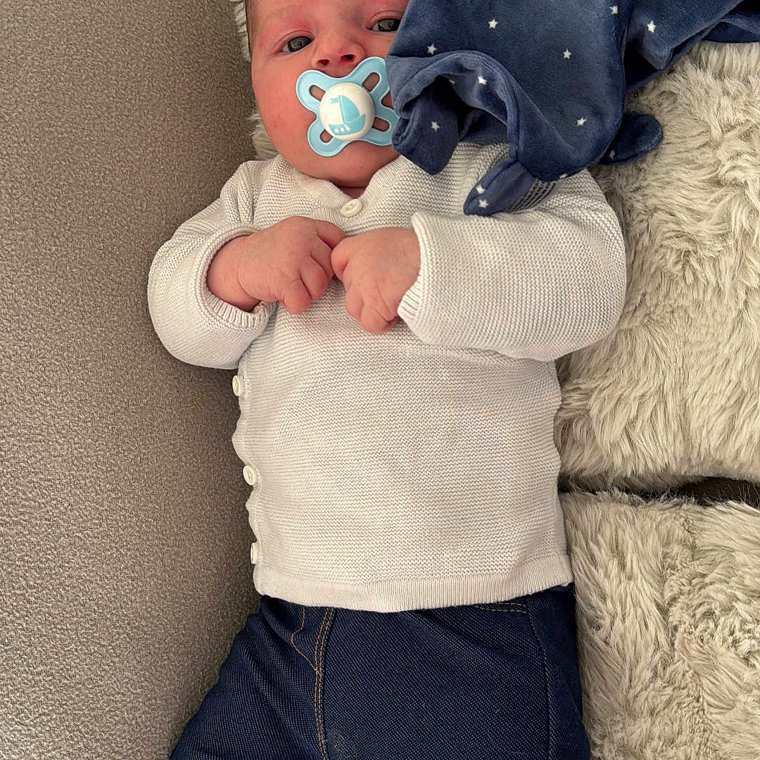 Timéo a rejoint le concours — aidez-le/la à gagner de superbes lots ! baby, blanket, bodypart, clothing, couch, cushion, face, finger, furniture, hand, hat, head, homedecor, jeans, knitwear, newborn, pants, person, photography, portrait