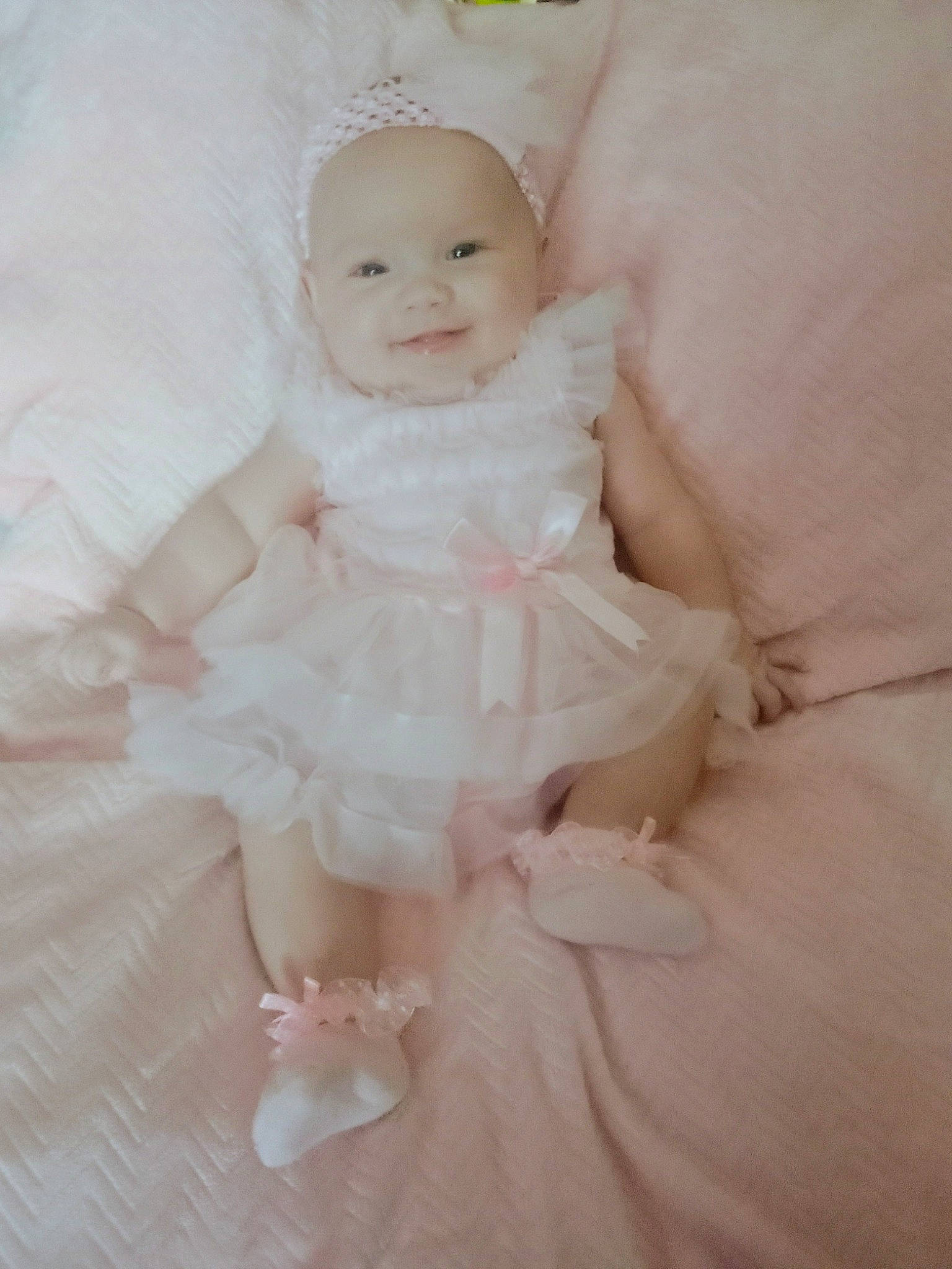 Kennedy is registered to the contest to win money with this photo: baby, baby_toddler_clothing, bridal_accessory, bridal_party_dress, day_dress, dress, embellishment, eye, face, flash_photography, happy, head, headgear, headpiece, iris, joy, one_piece_garment, person, pink, sleeve