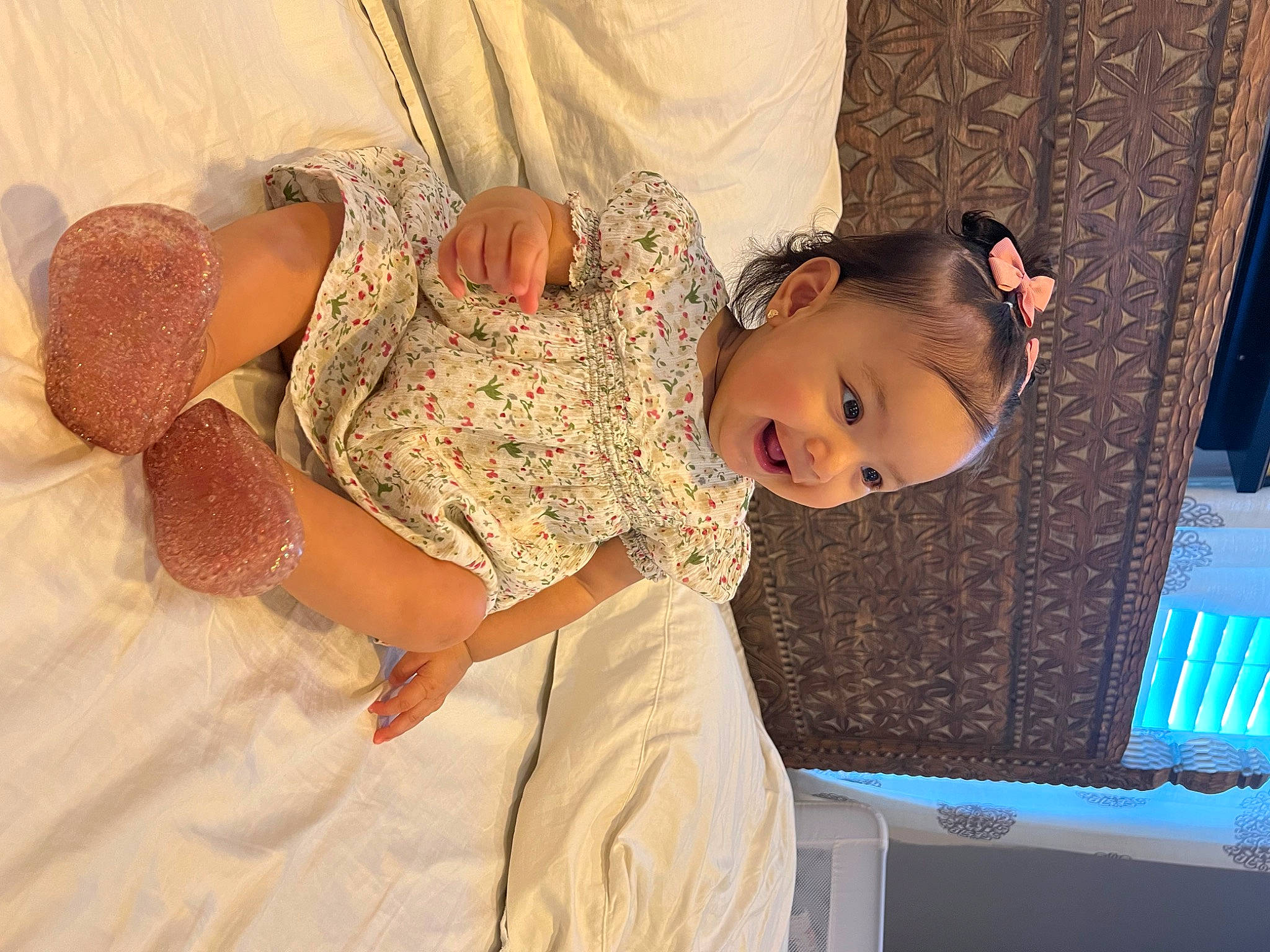 Alaya is registered to the contest to win money with this photo: abdomen, baby, baby_toddler_clothing, bed, bedding, child, comfort, curtain, dress, fun, happy, linens, pattern, peach, person, room, sitting, skin, toddler, trunk