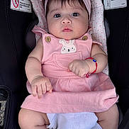 Elizabeth joined the competition — help win amazing prizes! baby, infant, pink_dress, headband, car_seat, warning_labels, blanket, bracelet, cute, child, portrait, indoor, clothing, person, seat, sitting, face, expression, young_child, adorable