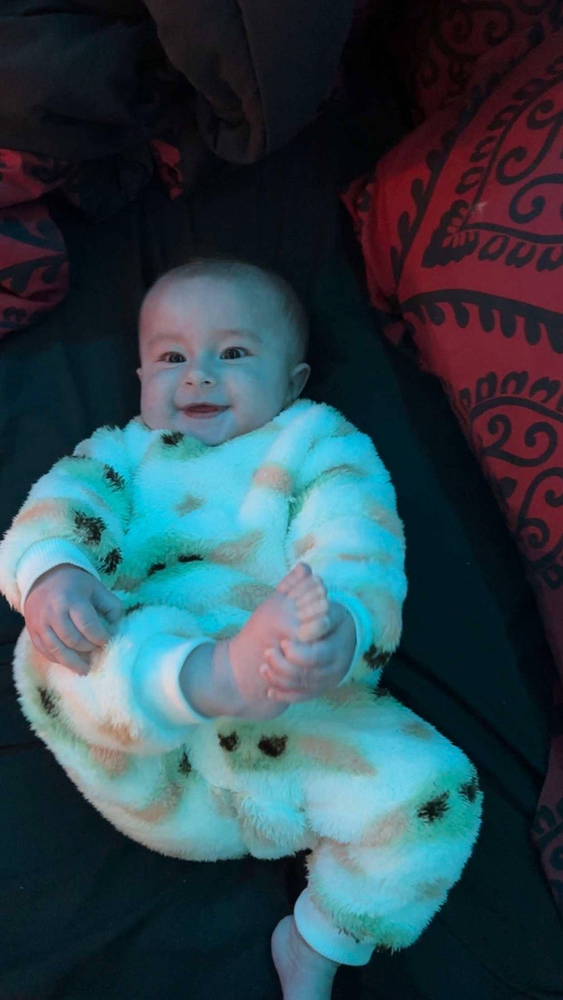 Benjamin is registered to the contest to win money with this photo: baby, baby_products, baby_toddler_clothing, cheek, child, chin, comfort, eye, fun, happy, head, iris, mouth, person, pink, room, sitting, skin, smile, textile