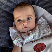 Charlotte joined the competition — help win amazing prizes! baby, infant, child, face, eyes, clothing, floral, seat, cushion, fabric, portrait, cute, expression, soft_lighting, ruffles, button, skin, head, comfort, indoor