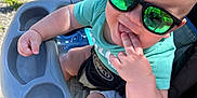 Ezekiel joined the competition — help win amazing prizes! baby, casual, child, closeup, cute, fingers, foot, green_shirt, happy, infant, outdoor, person, plastic, playful, reflection, seat, stroller, summer, sunglasses, sunlight