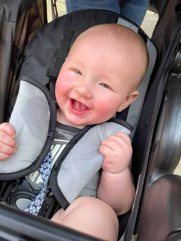 Eli is registered to the contest to win money with this photo: auto_part, baby, baby_carriage, baby_in_car_seat, baby_products, baby_toddler_clothing, car_seat, cheek, child, comfort, eye, finger, person, seat_belt, skin, smile, steering_part, steering_wheel, thigh, toddler