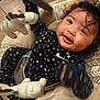 Navaya is registered to the contest to win money with this photo: baby, child, infant, smiling, toy, stuffed_animal, zebra, cushion, seat, indoor, happy, clothing, patterned, face, hand, hair, person, playful, comfort, closeup