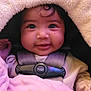 Navaya is registered to the contest to win money with this photo: baby, child, infant, face, smile, blanket, car_seat, harness, clothing, cute, close_up, soft_texture, pink, warm, young_child, portrait, indoors, happy, baby_girl, toddler