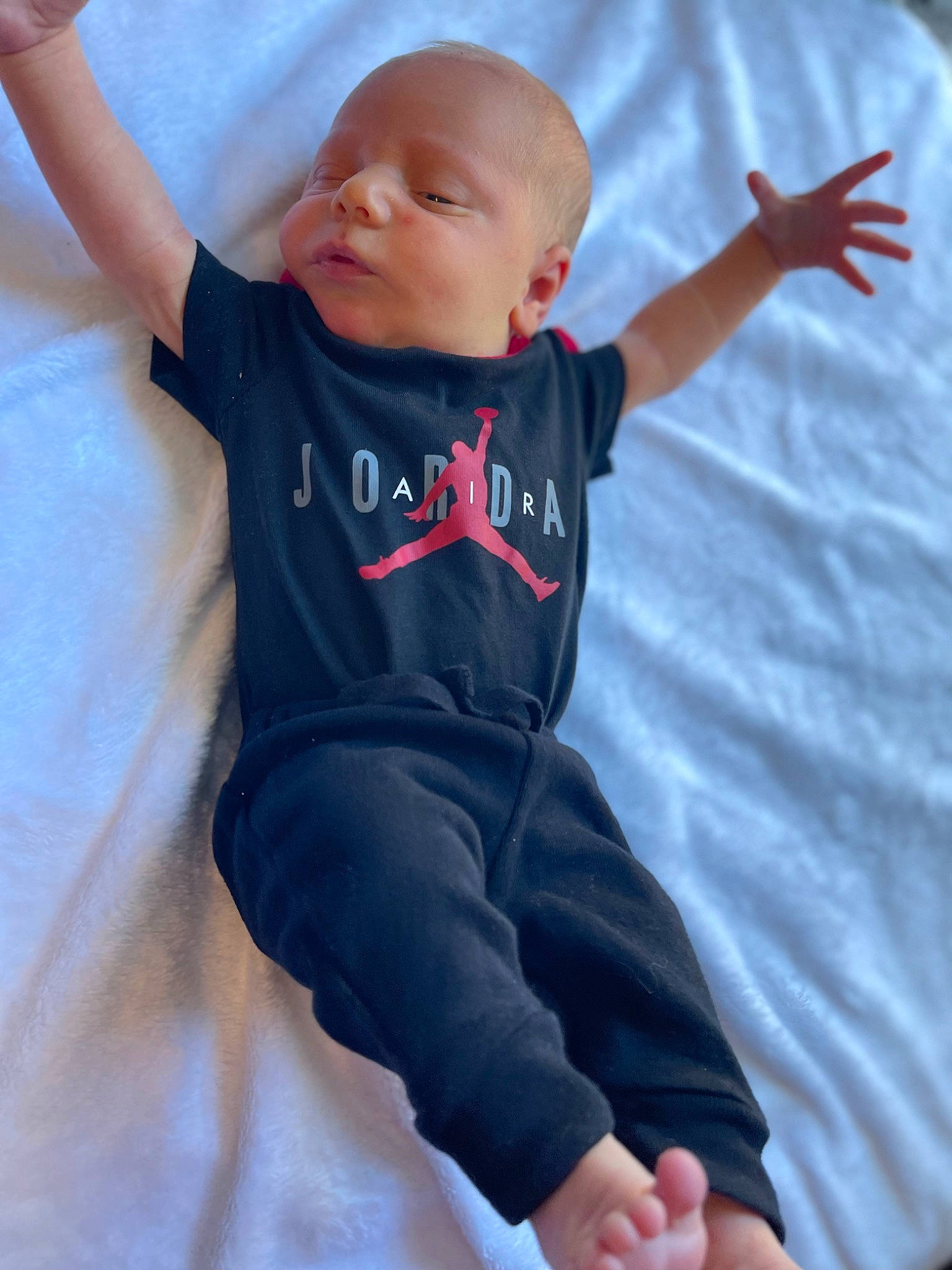 Branson is registered to the contest to win money with this photo: azure, baby, baby_toddler_clothing, child, comfort, elbow, electric_blue, eye, finger, fun, gesture, happy, human_leg, pattern, person, sitting, skin, sleeve, t_shirt, thumb