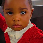 Janaya participe au concours pour gagner de l'argent avec cette photo : toddler, child, portrait, face, expression, curly_hair, red_sweater, white_shirt, indoor, person, cute, young_child, hairstyle, pigtails, looking_at_camera, skin_tone, earrings, serious_face, closeup, fashion